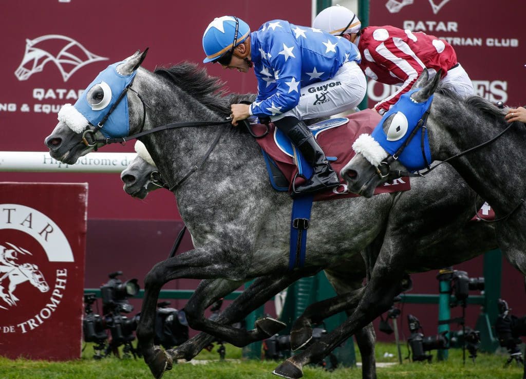 Maxime Guyon celebrates after riding Gazwan (blue) to win The Qatar Arabian World Cup during Prix de l'Arc de Triomphe meeting at Chantilly Racecourse on October 1, 2017 in Chantilly, France.