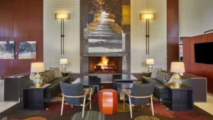 Cosy hotel lobby with fireplace and modern decor.