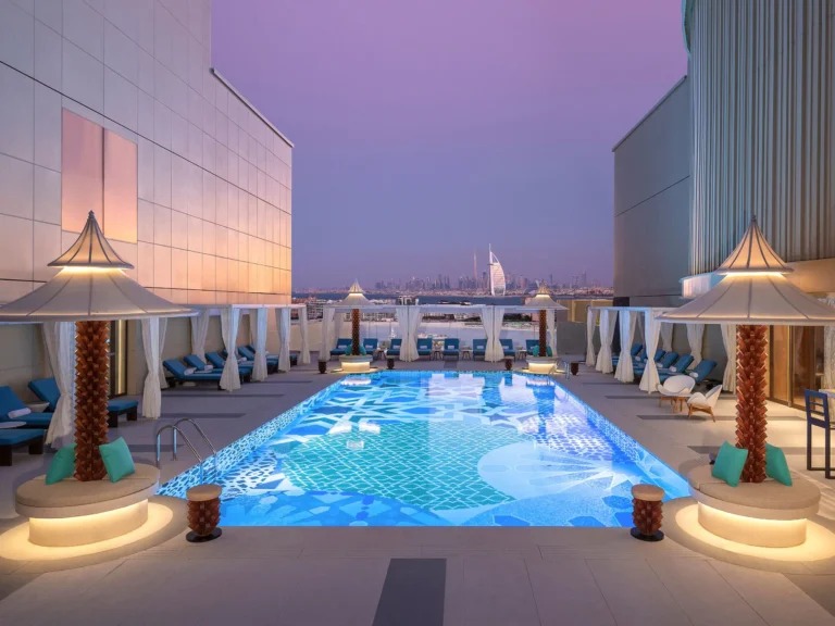 Luxury rooftop pool overlooking Dubai skyline at dusk